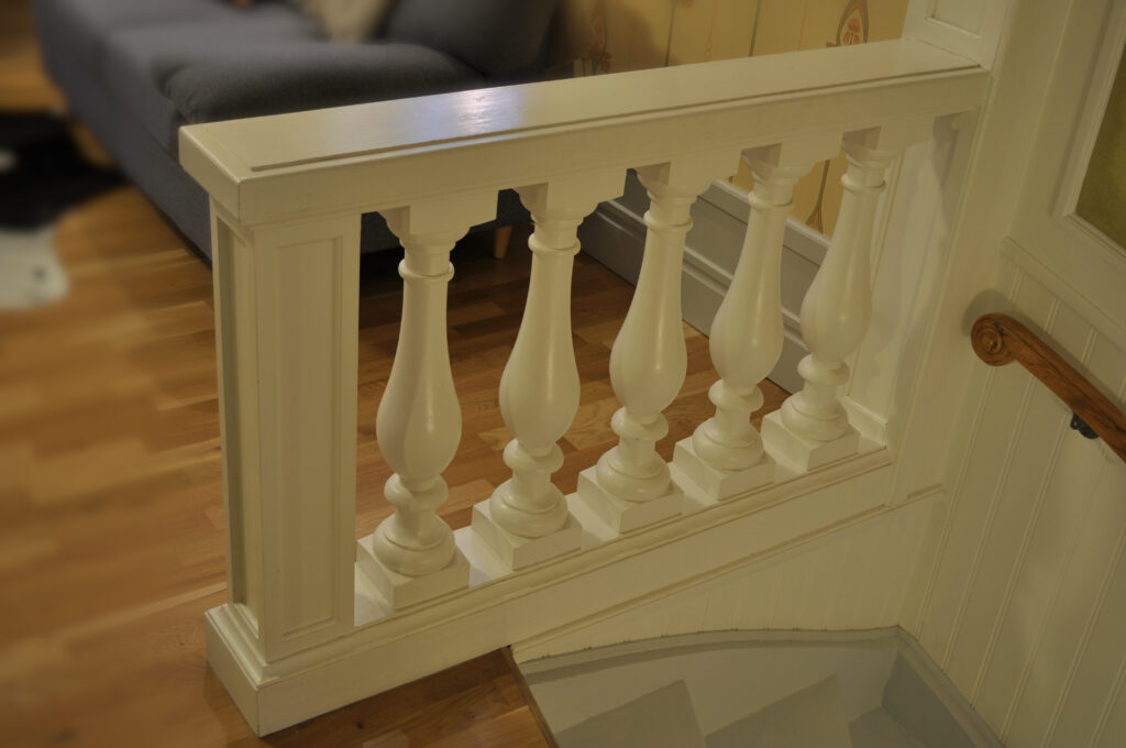 Wooden balustrade. Detail of villa interior.
