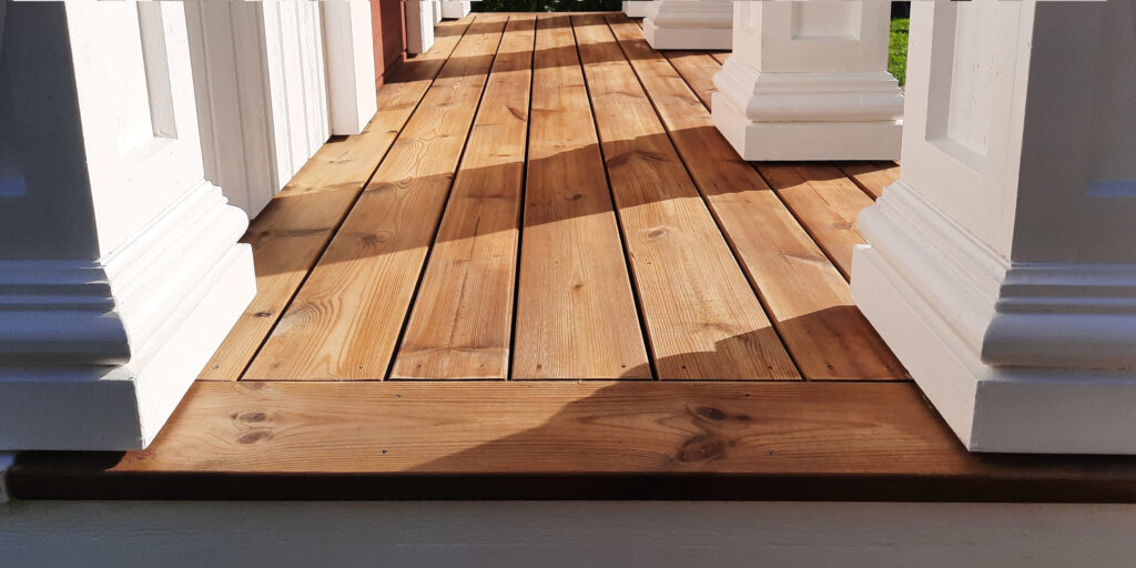 Portico floorboards (preassure-treated thus moisture-resistant) and doric column bases